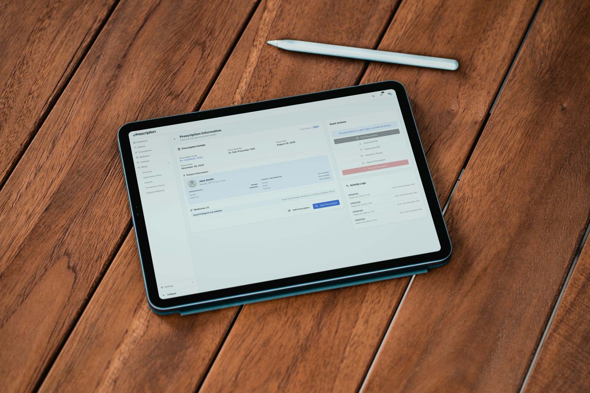 The prescription screen open on a tablet lying on a wooden desk, a stylus beside it