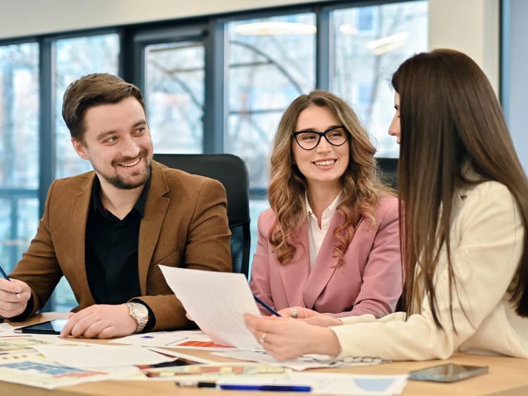 A mentor going through work with two colleagues