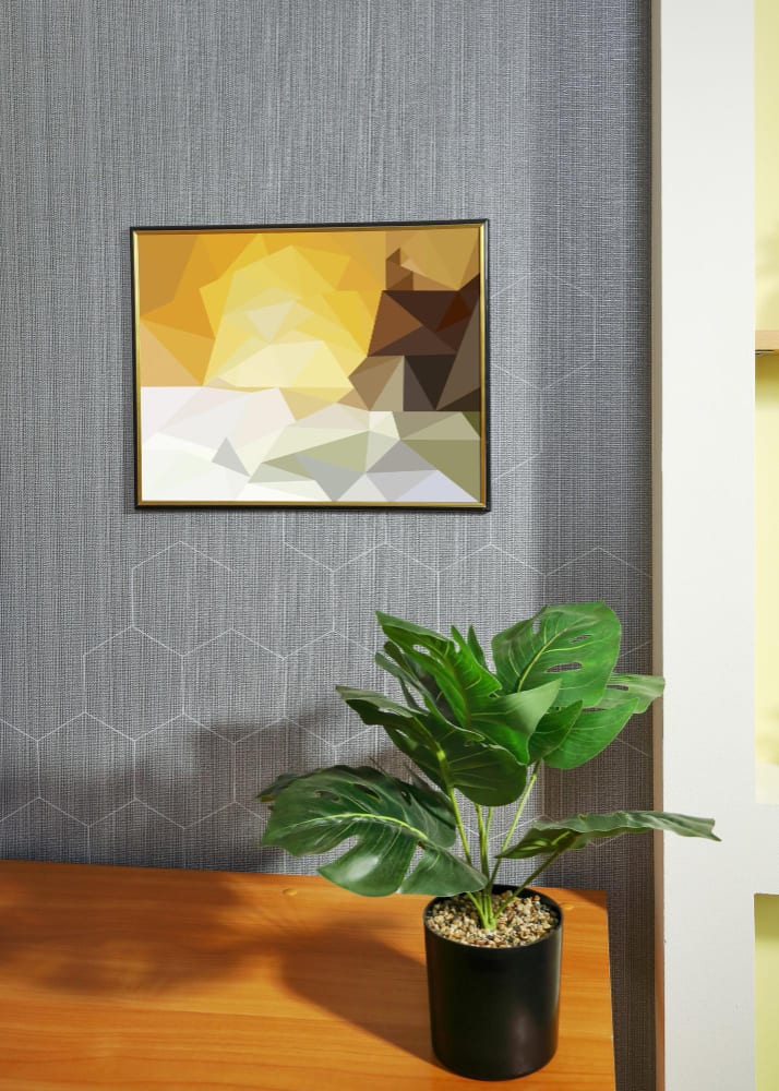 A framed print and a plant in the office
