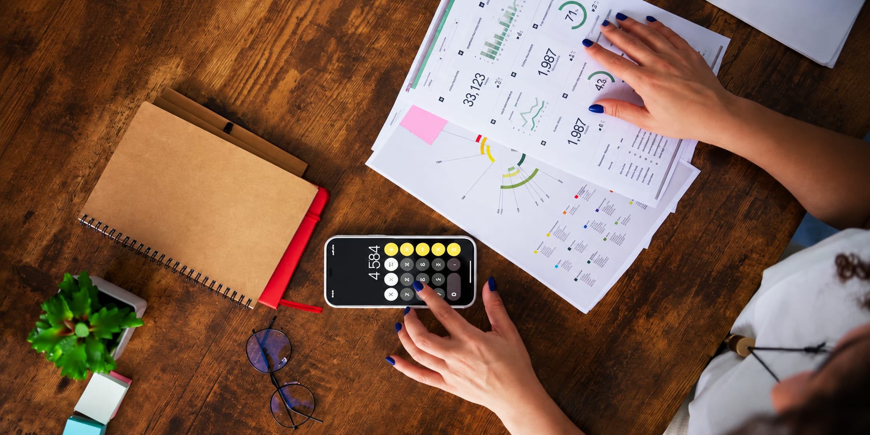 A person reviewing pricing analytics with a calculator