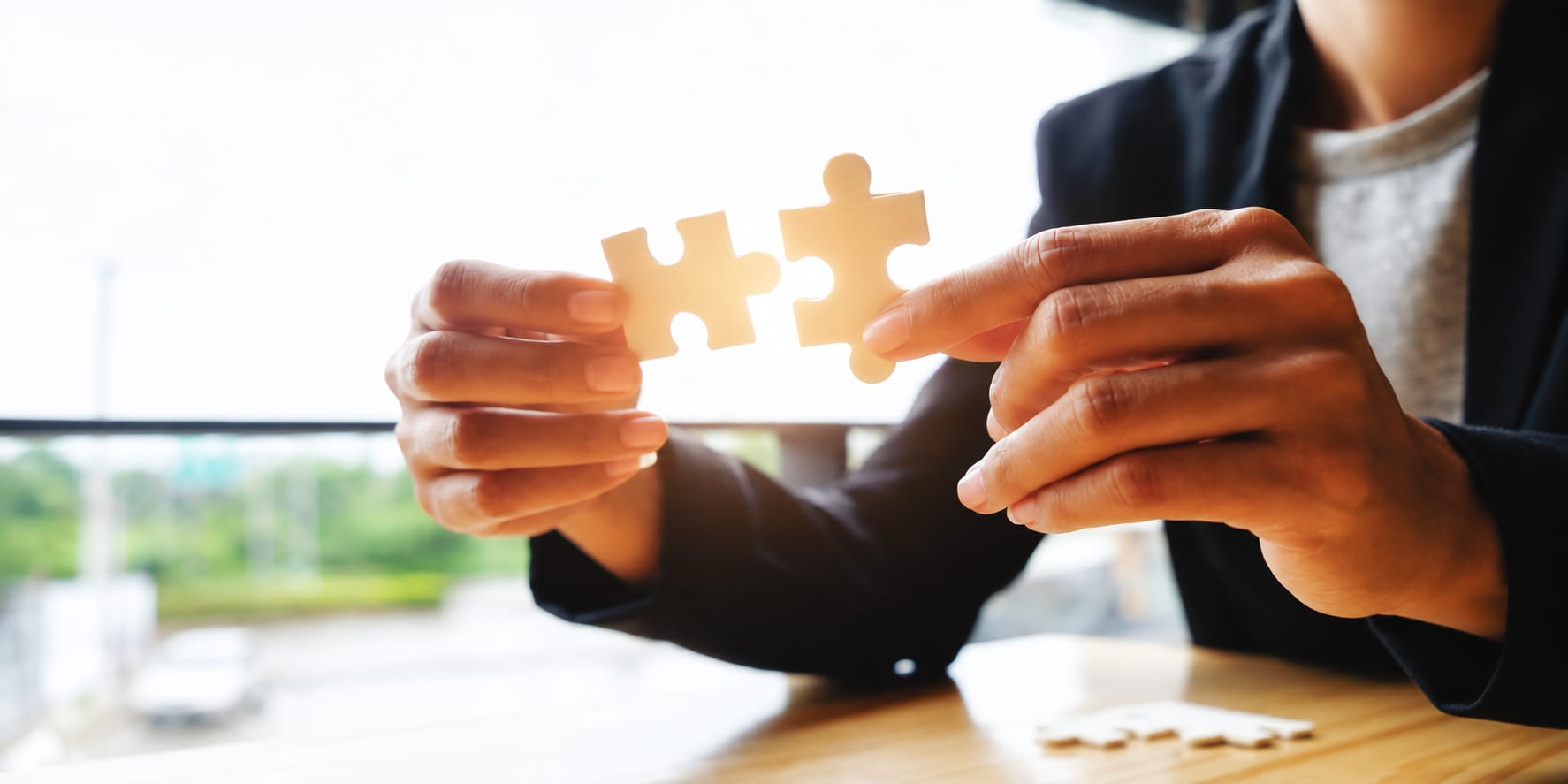 A business professional joining two puzzle pieces