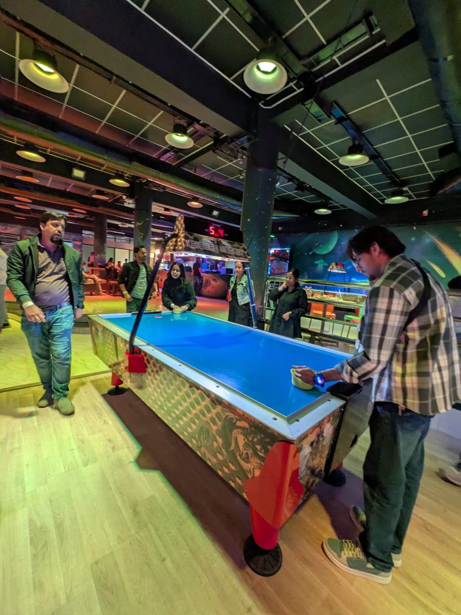 The team playing air hockey on a night out